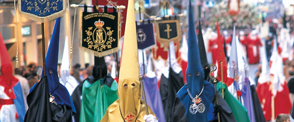 Members of the religious brotherhoods marching in procession through the streets of Ferrol, A Coruña © Turgalicia