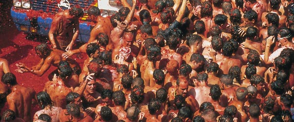 People in the street throwing tomatoes during the Tomatina tomato festival. Buñol, Valencia © Turespaña